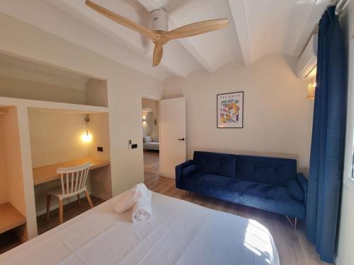 a living room with a blue couch and a table at Picasso Mountain View Begur in Begur