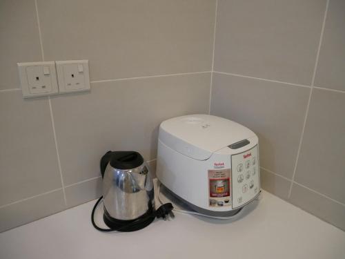a toaster sitting on a counter next to a blender at vivacity megamall jazz suites 2 kuching in Kuching