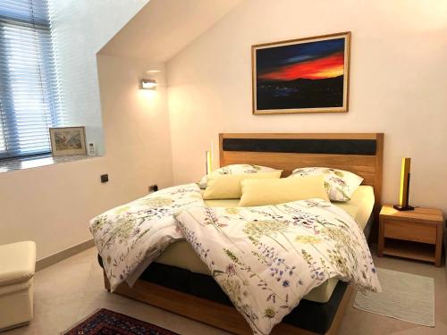 a bedroom with a bed and a painting on the wall at Panorama View in Jalovec