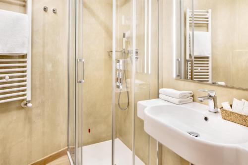 a bathroom with a sink and a shower at Hotel Italia in Cagliari