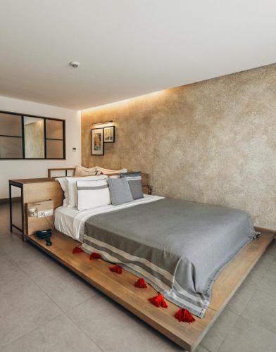 a bedroom with a large bed on a wooden platform at Club Marvy in Ozdere