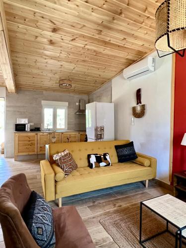 a living room with a couch and a kitchen at Hacienda la Yerbabuena in Cádiz