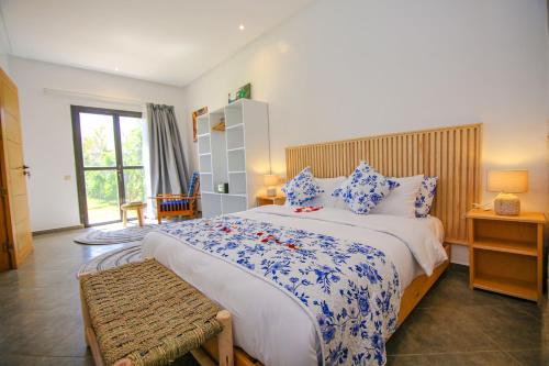 a bedroom with a large bed with blue and white at Villa La Rose Bleue - Résidence Hôtelière avec Piscine - Essaouira in Essaouira
