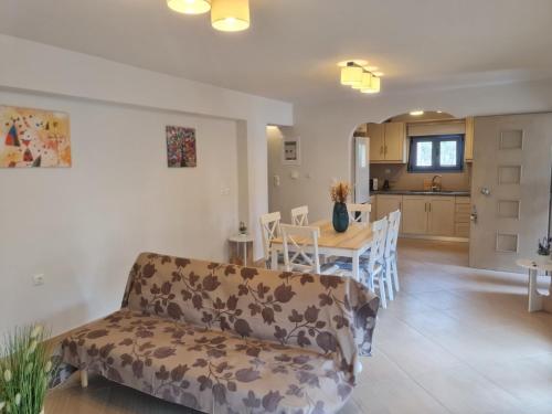 a living room and kitchen with a couch and a table at Maria's family house 1 in Elafonisos
