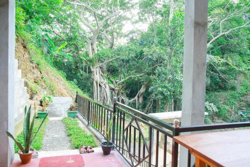 a balcony with a view of a garden at Banyan Shade Mirissa in Mirissa