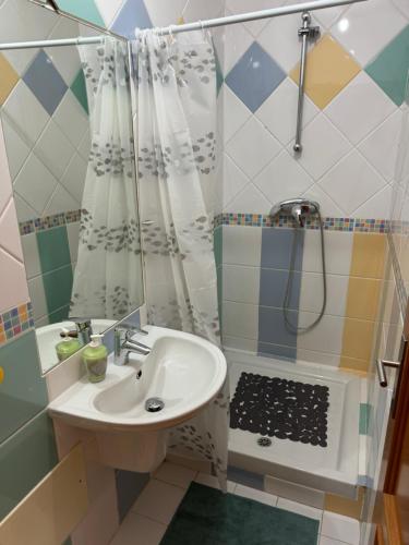 a bathroom with a sink and a shower at Montenegro Dreams in Faro