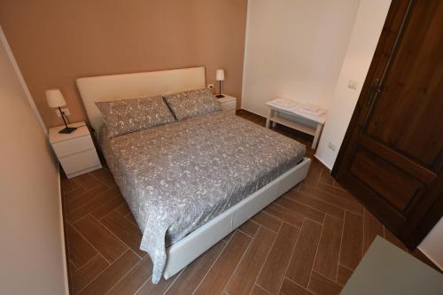 a small bedroom with a bed and two night stands at Dream House in Piazza Armerina