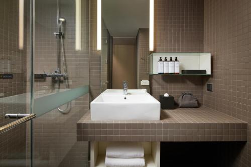 a bathroom with a white sink and a shower at Shilla Stay Seocho Gangnam Station in Seoul