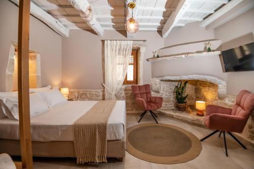 a bedroom with a bed and a stone fireplace at Pavlina Villa , a hidden gem with heated pool and ping pong! in Perama