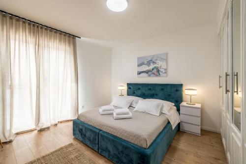 a bedroom with a blue bed with a blue headboard at Apt with best rated breakfast ZAP B&B in Split