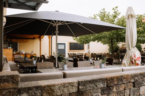 a table with an umbrella on a patio at Landhotel Gary in Wolframs-Eschenbach
