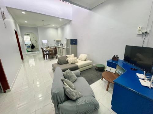 a living room with a couch and a tv at Aqua Shelter in Mersing