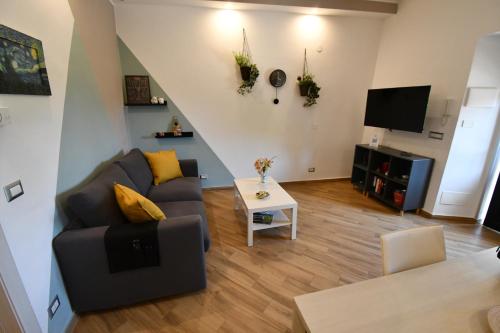 a living room with a couch and a tv at Dream House in Piazza Armerina