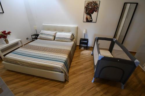 a bedroom with a bed in a room with wooden floors at Dream House in Piazza Armerina