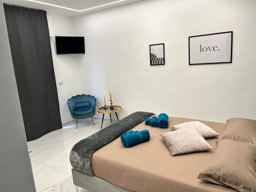 a bedroom with a bed with blue pillows on it at Luxury Beach House in Bari
