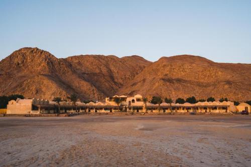 a group of buildings in front of a mountain at Aqua Sun in Nuweiba