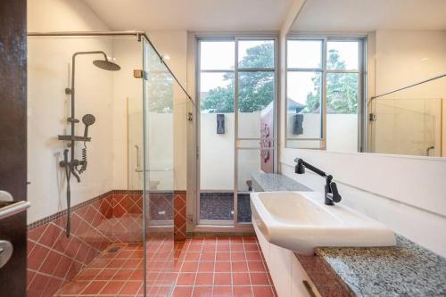 a bathroom with a glass shower and a sink at Sorrento Pool Villa Naga Jomtien Pattaya in Na Jomtien