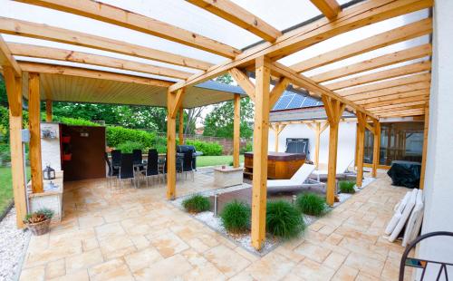 a wooden pergola with a patio at Villa Quality Wellness in Dozmat