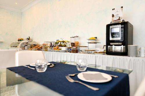 a table with a plate and fork and a microwave at Blumarin in Lido di Jesolo