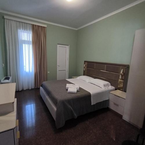 a bedroom with a bed with two towels on it at 4 Bed Villa-Sleeps 8-Parking-Garden-Sea View in Ureki