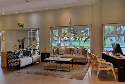 a living room with a couch and a table at Cresta Lodge Harare in Harare