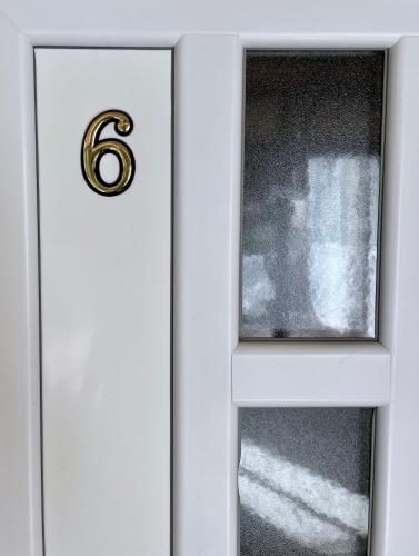 a white door with a number six on it at Apartment Velago in Zlatibor