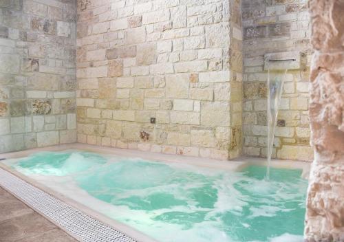 a jacuzzi tub with a water fountain at Trulli e Puglia Luxury Suite in Alberobello