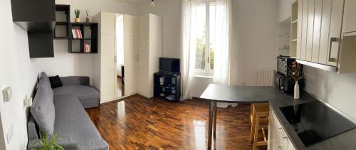 a living room with a couch and a table at Magico Relax Bordighera-Open space con piscina e vista mare in Bordighera
