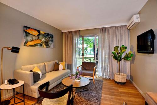 a living room with a couch and a table at Cresta Lodge Harare in Harare