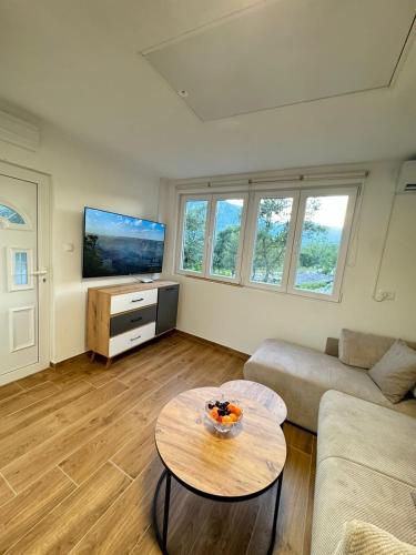 a living room with a couch and a table at Villagio in Virpazar