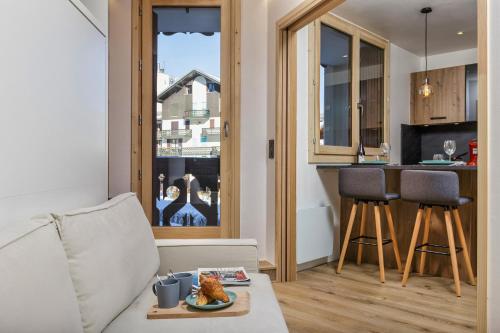 un salon avec un canapé et une cuisine dans l'établissement Chamonix Sud - Triolet A109 - Happy Rentals, à Chamonix-Mont-Blanc