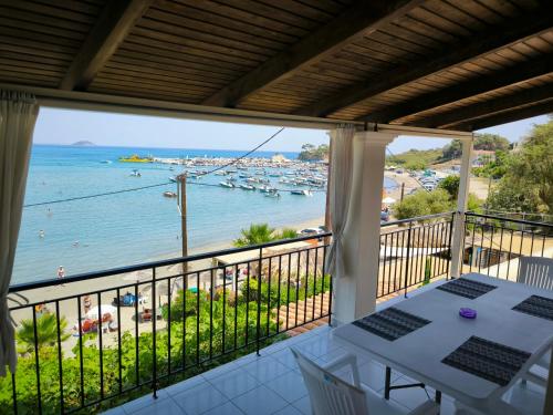 a balcony with a view of the ocean and boats at Aggelika Apartments in Lithakia