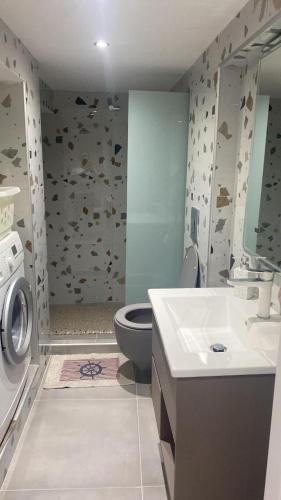 a bathroom with a toilet and a sink at Carnagio All Season in Kavála