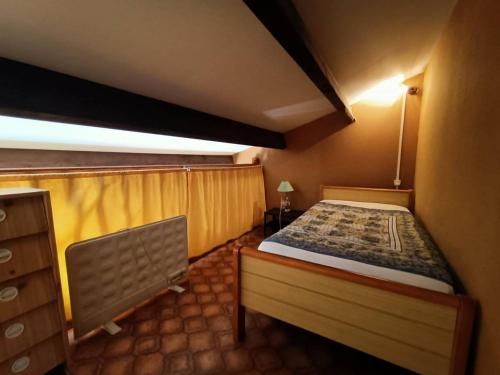a bedroom with a bed and a nightstand and avertisement at Maison à 150 m Plage 6LT221 in Saint Pierre La Mer