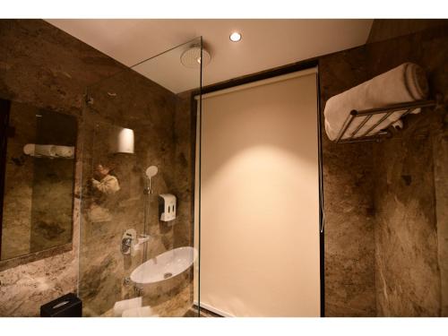 a bathroom with a shower and a sink at Belvedere Suites in Greater Noida