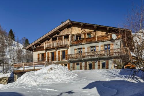 a large wooden house in the snow at La Ferme à Roland ski in - ski out - Happy Rentals in Chamonix-Mont-Blanc