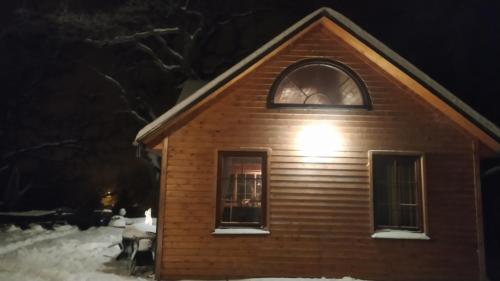 a house with a light on top of it in the snow at Jumpravas pils in Jumprava