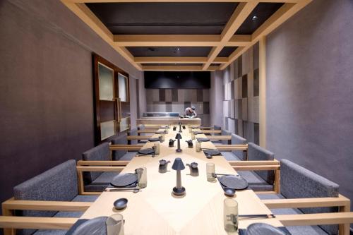 a conference room with long tables and benches at Islamabad Marriott Hotel in Islamabad