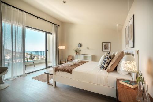 a bedroom with a large bed and a large window at Payava Hotel by True Blue in Kalkan