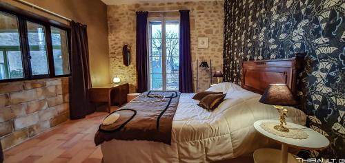 Ένα ή περισσότερα κρεβάτια σε δωμάτιο στο LA DEMEURE Bed and Breakfast