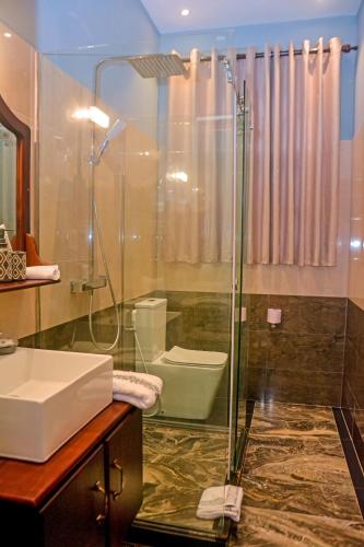 a bathroom with a shower and a sink and a toilet at Elisach Serenity House - 4 BHK Villa in Sri Lanka - near to Airport in Negombo