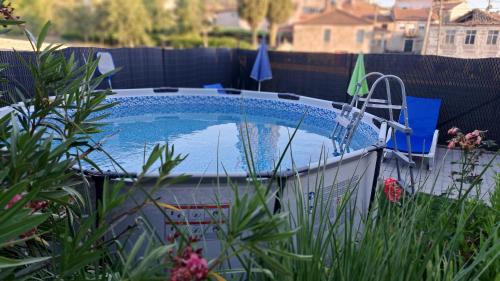 a swimming pool in a yard with plants at Casa do Vicente in Tabuaço