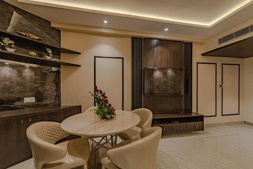 a dining room with a table and chairs at Goldfinch Hotel Mangalore in Mangalore