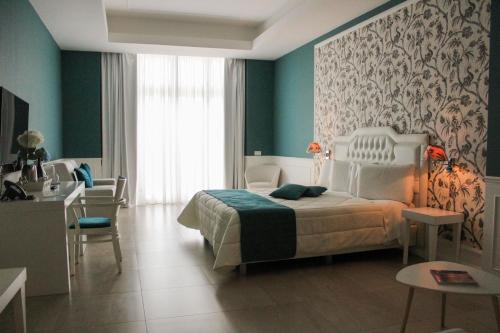 Ein Bett oder Betten in einem Zimmer der Unterkunft Bianco Riccio Suite Hotel