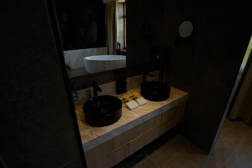 a bathroom with two black bowls on a counter at Ulaanbaatar Hotel in Ulaanbaatar