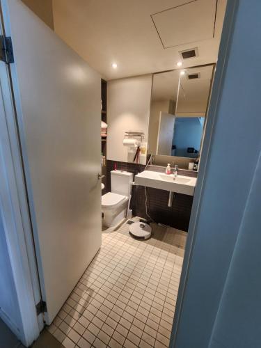 a bathroom with a toilet and a sink at One bedroom apartment in Docklands in Melbourne