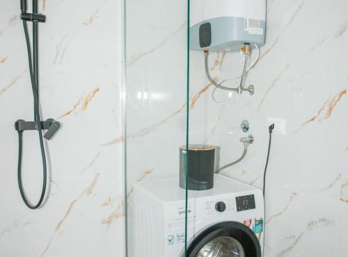 a washing machine in a bathroom with a shower at Apartment Matko in Ploče