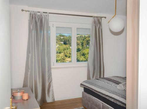 a bedroom with a bed and a window at Apartment Matko in Ploče