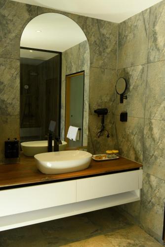 a bathroom with a sink and a mirror at Ulaanbaatar Hotel in Ulaanbaatar