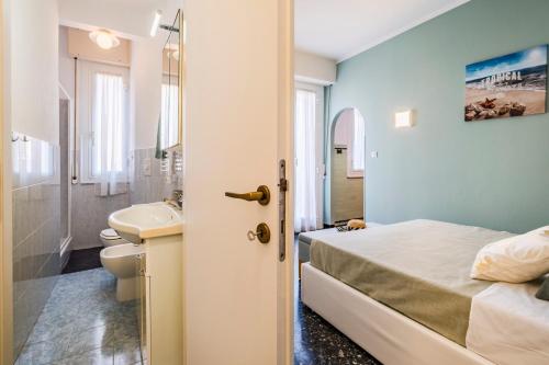 a bedroom with a bed and a sink and a toilet at Sestri Levante Acquamarina in Sestri Levante